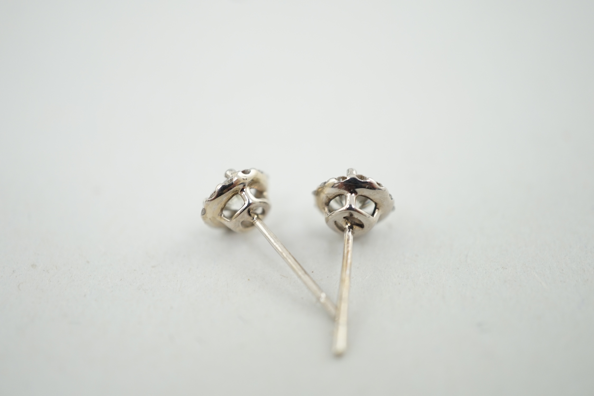 A modern pair of 18ct white gold and diamond cluster set ear studs